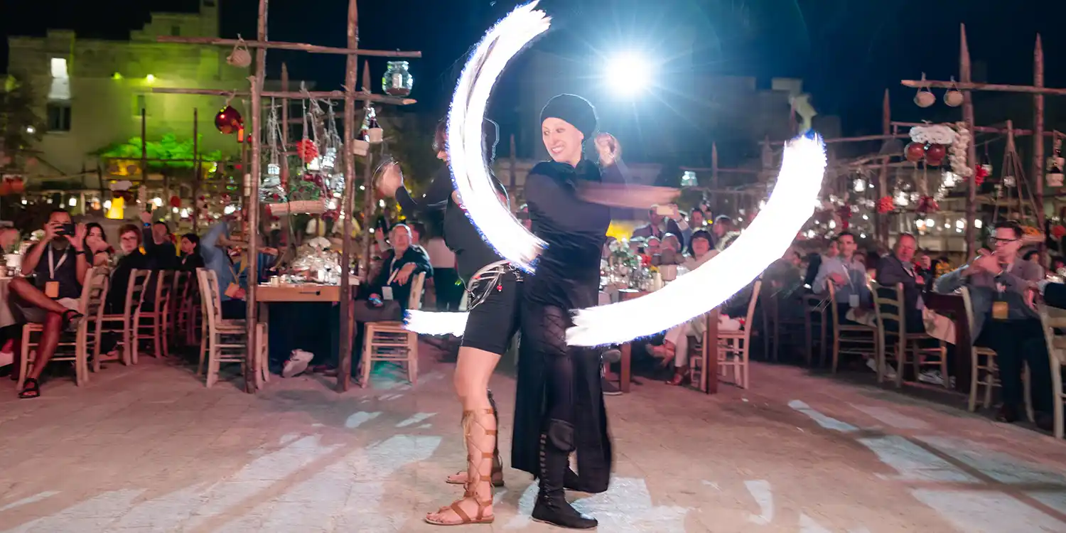 Light dancers entertaining incentive travel attendees